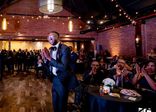 Addressing guests at a Gentlemen's Factory gala.